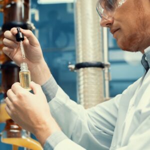 man extracting CBD using a dropper