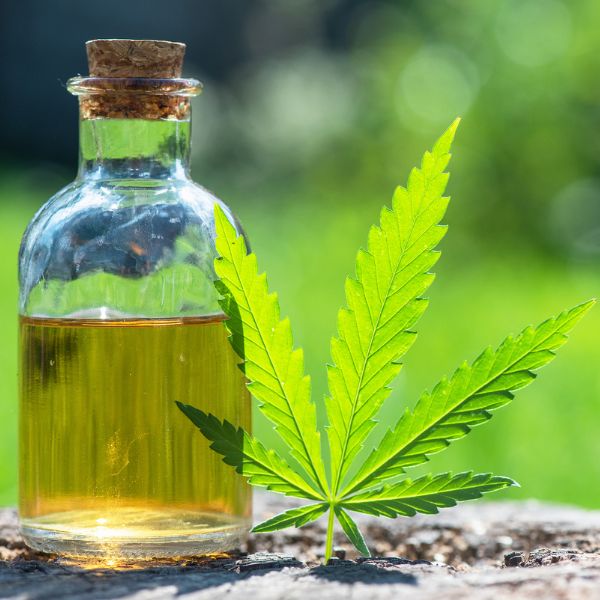 Small glass with stopper filled with CBD oil